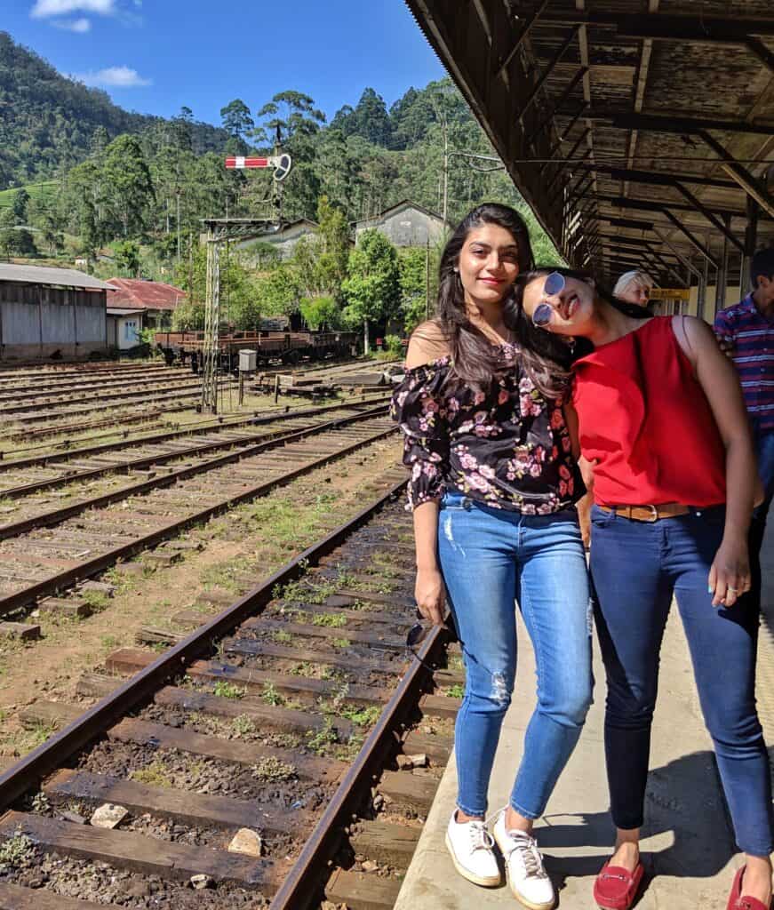 2 girls standing by railway tracks in Nuwara Eliya, Sri Lanka