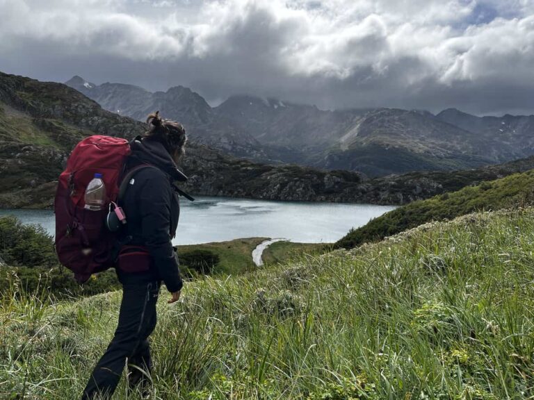 A girl standing with a backpack.