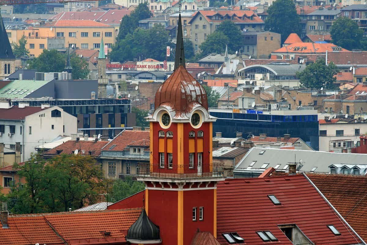 Exterior of the Sarajevo Brewery (Sarajevska Pivara), a historic red-brick building with arched windows, located near the Miljacka River — known for surviving wars and supplying the city with water during the siege.