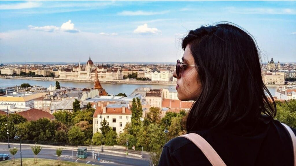 Girl overlooking the view of Danube and the Pest side of Budapest