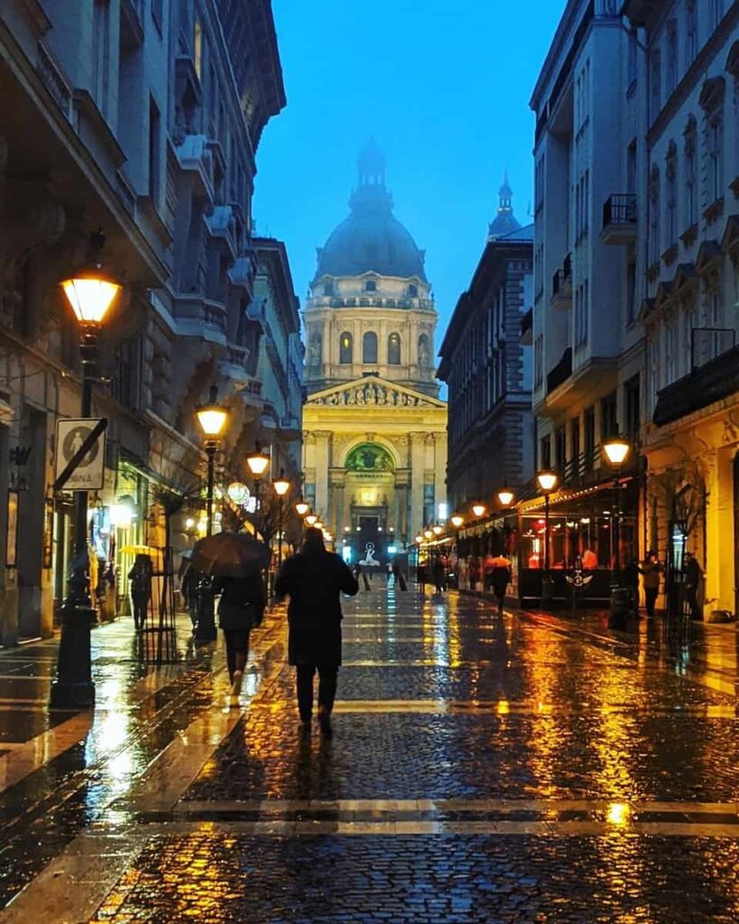 St. Stepehns Bascillica captures froma street lit with lamps in rain