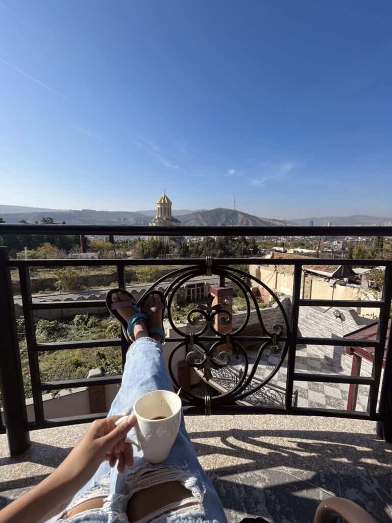 Image of coffee cup on a balcony overlooking Tbilisi