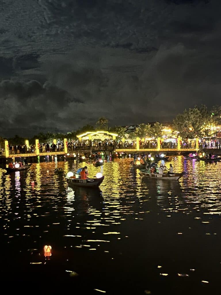 River with boats and lanterns on a cloudy night