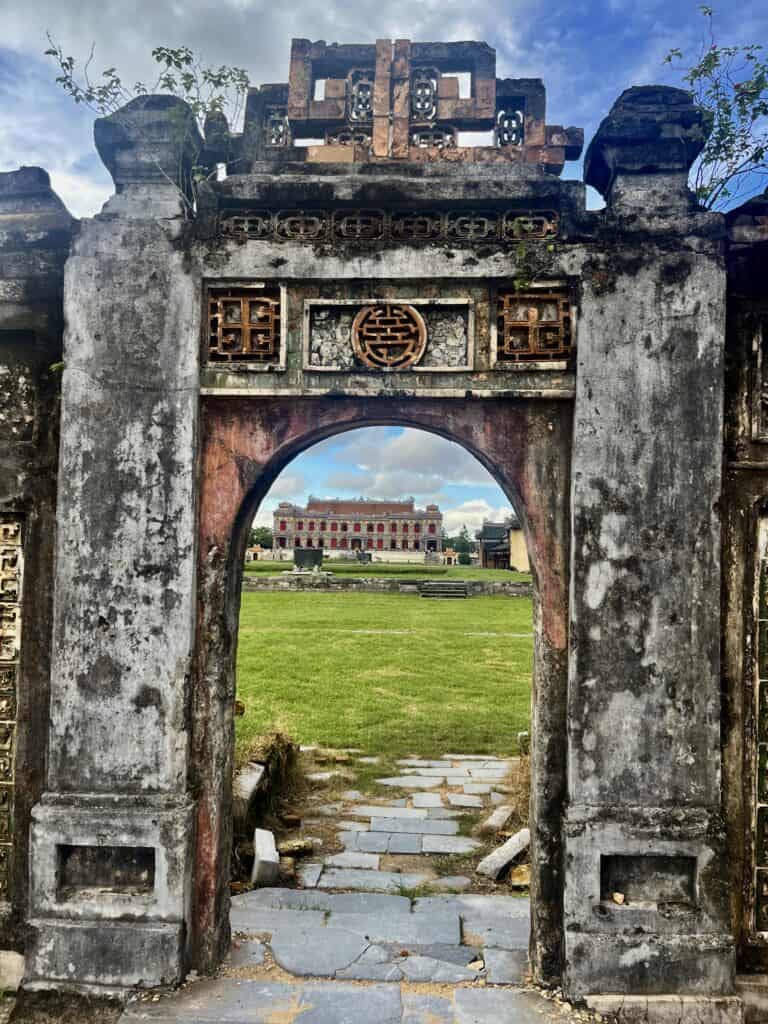 An old age stone doorway with palace visible in the background