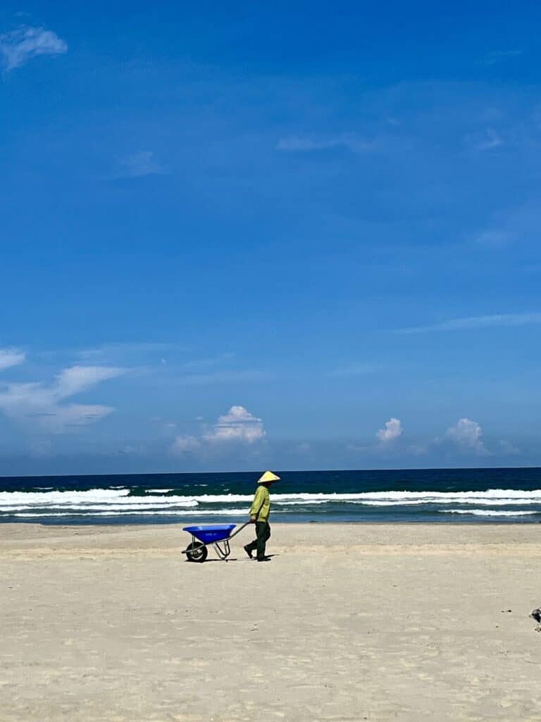 Local fisherman pulling cart on a beach