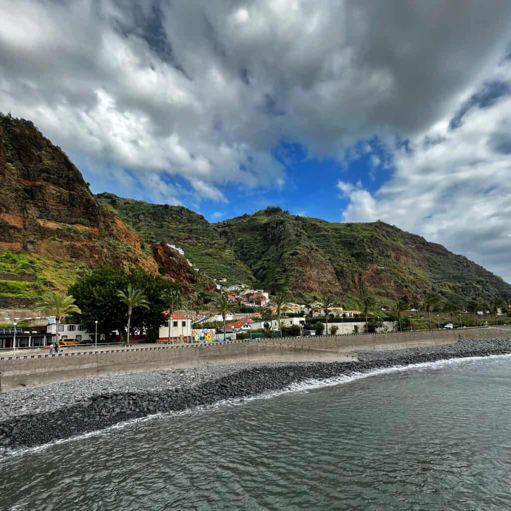 Hills of Madeira under a cloudy sky viewed from the water 