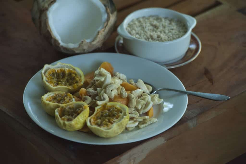 A healthy breakfast with passion fruit, cashews, and fresh coconut in Dambulla, Sri Lanka.