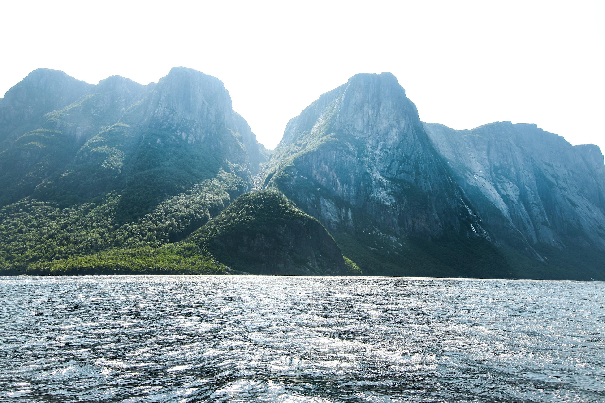 Stunning view of towering mountains and shimmering sea in Gros Morne, Newfoundland, Canada.