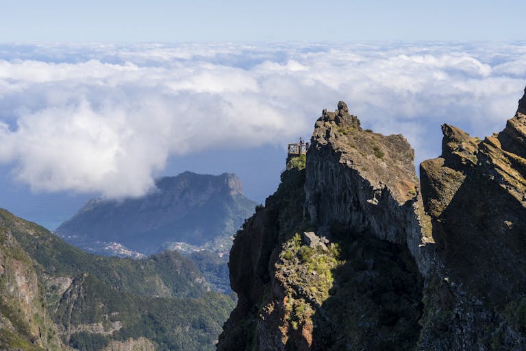 Stunning high-altitude viewpoint at Pico Arieiro, Madeira with dramatic cliffs and clouds.