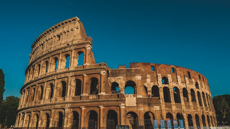 Stunning view of the ancient Roman Colosseum in Rome, Italy, captured at sunset showcasing its historic arches, symbolizing what to do in 2 days in Rome