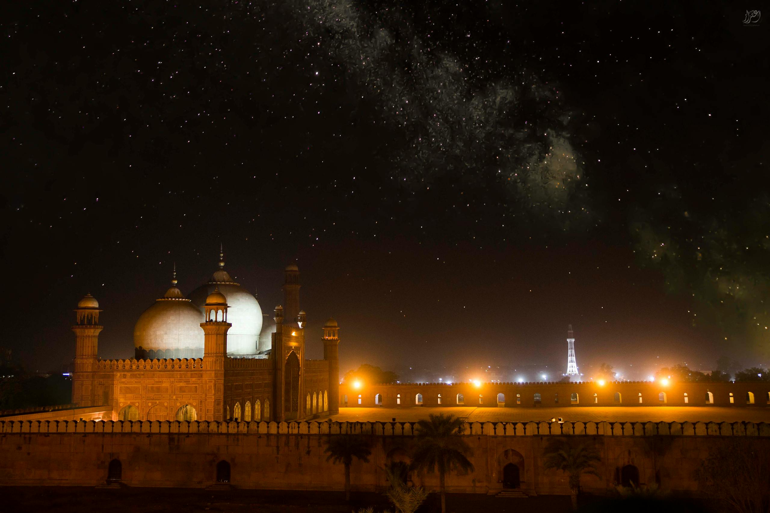 The historic Badshahi Mosque in Lahore shines brightly under a captivating starry night.